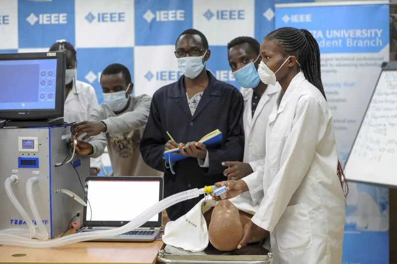 In this Monday, April 13, 2020 file photo, medical students test a self-designed computer-controlled ventilator prototype at the Chandaria Business and Incubation Centre of Kenyatta University in Nairobi, Kenya. More than two dozen international aid organizations have told the U.S. government they are 