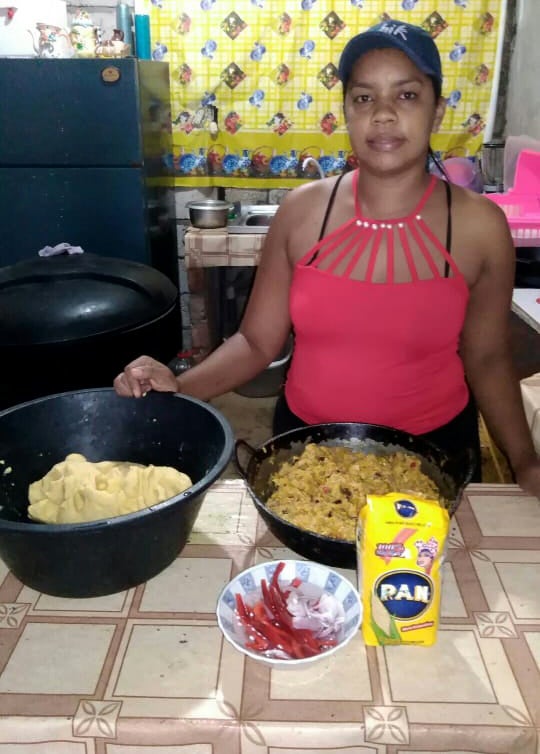 A woman prepares food in a kitchen.