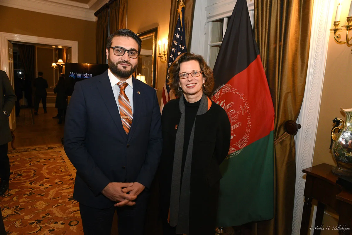 CARE CEO Michelle Nunn and Ambassador Hamdullah Mohib stand in front of both the American and Afghan flags