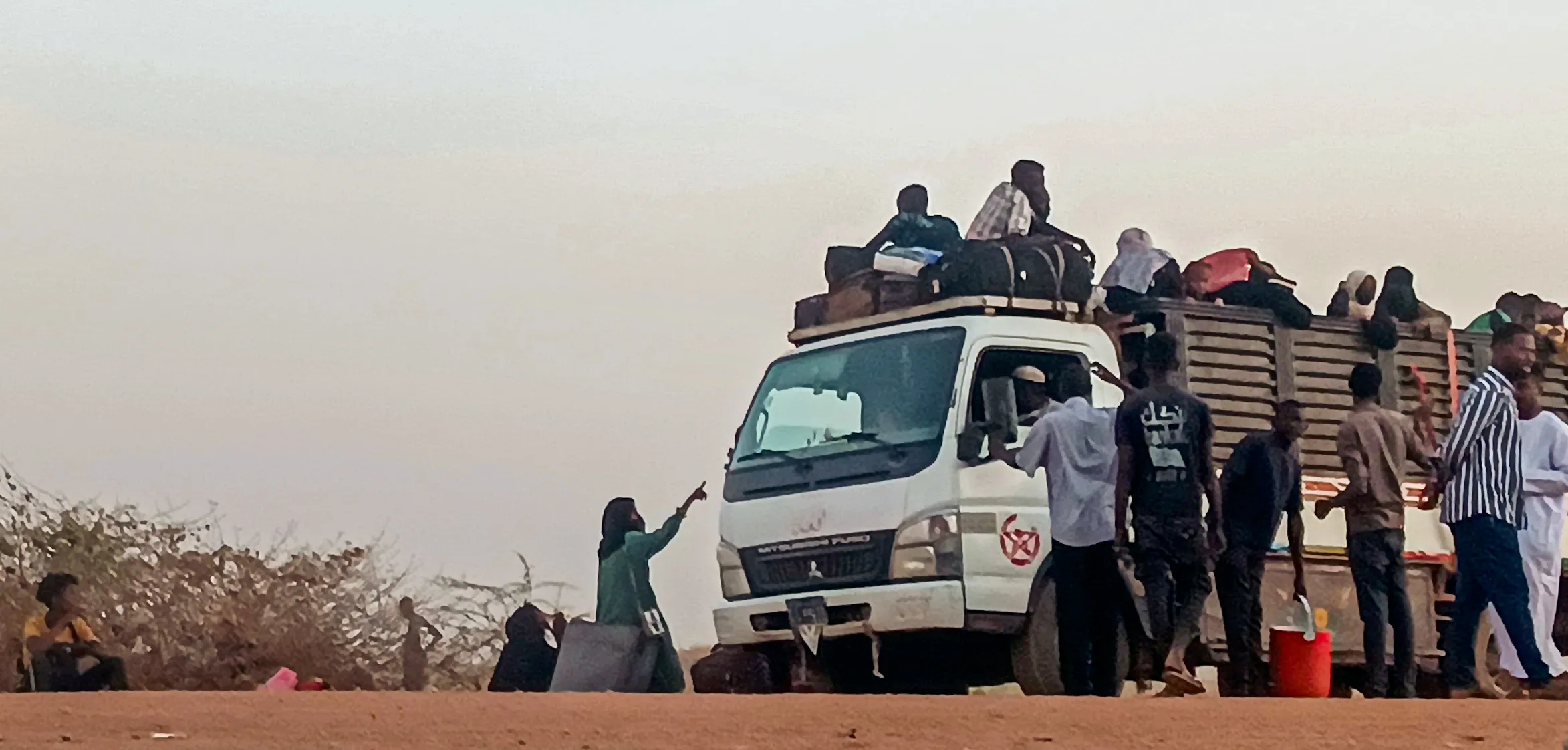 A group of people standing on top of a truck