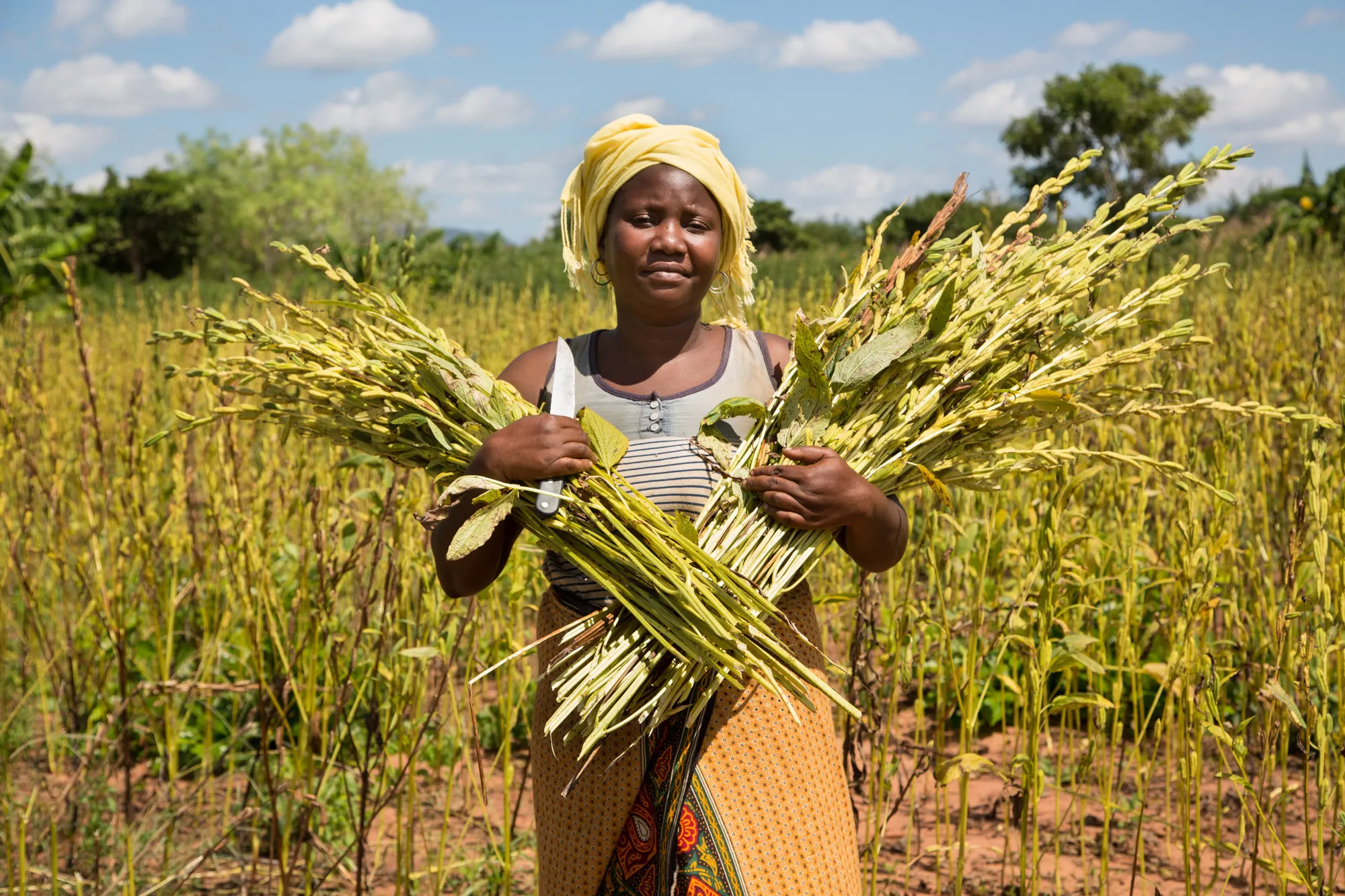 Woman proudly holds crops