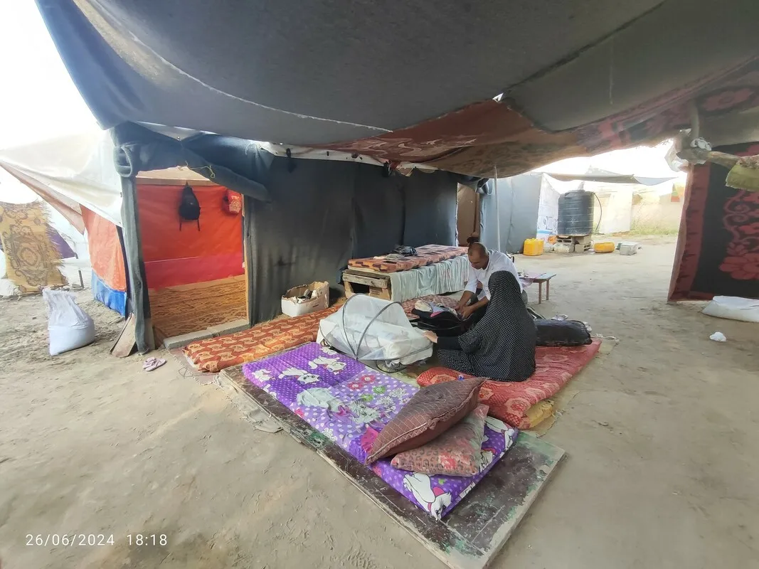 Displaced parents in Gaza care for their triplet babies in a makeshift tent.