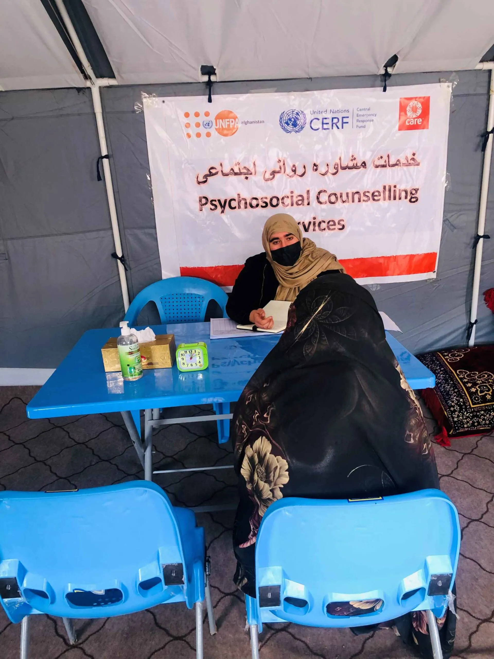 An Afghan woman named Zahra, an earthquake survivor, attends a psychosocial counseling session with a female counselor.